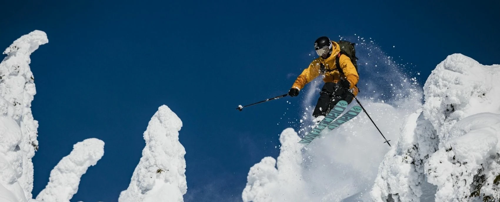 Thrilling skier slashing through untouched snow at Revelstoke, showcasing the benefits of the Mountain Collective pass