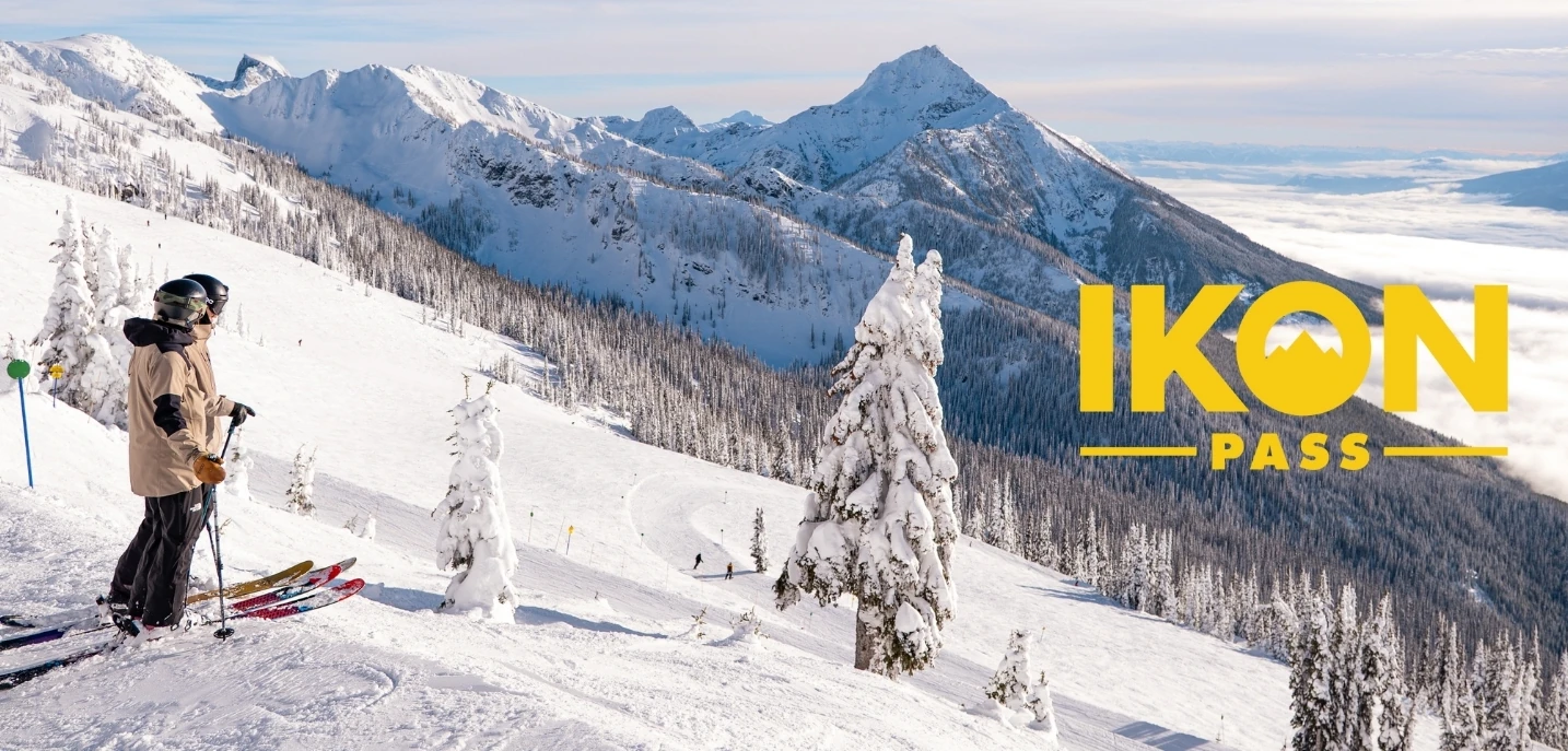 Skier carving through powder under a clear blue sky promoting the Ikon Pass, offering access to 60+ world-class ski destinations