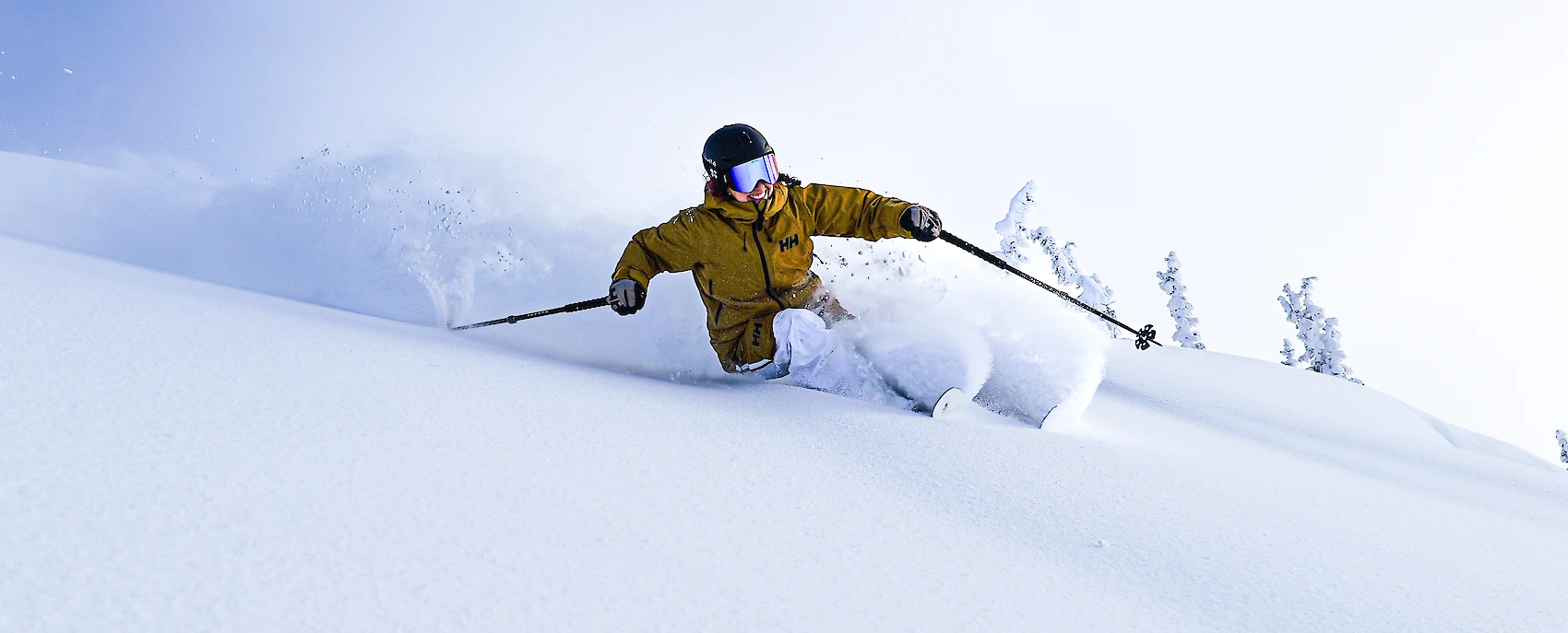 Freeride skier gliding through untouched powder in Revelstoke, British Columbia, showcasing epic snow conditions and mountain adventure