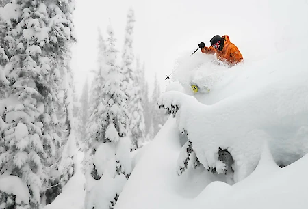 Adventure skier enjoying deep powder and epic terrain at Revelstoke Mountain Resort in British Columbia, a top destination for winter vacations in Canada