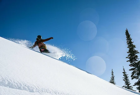 Adventure skier enjoying deep powder and epic terrain at Revelstoke Mountain Resort in British Columbia, a top destination for winter vacations in Canada
