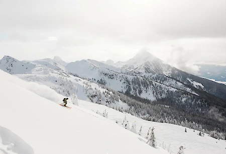 Adventure skier enjoying deep powder and epic terrain at Revelstoke Mountain Resort in British Columbia, a top destination for winter vacations in Canada