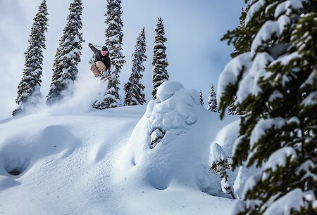 Adventure skier enjoying deep powder and epic terrain at Revelstoke Mountain Resort in British Columbia, a top destination for winter vacations in Canada
